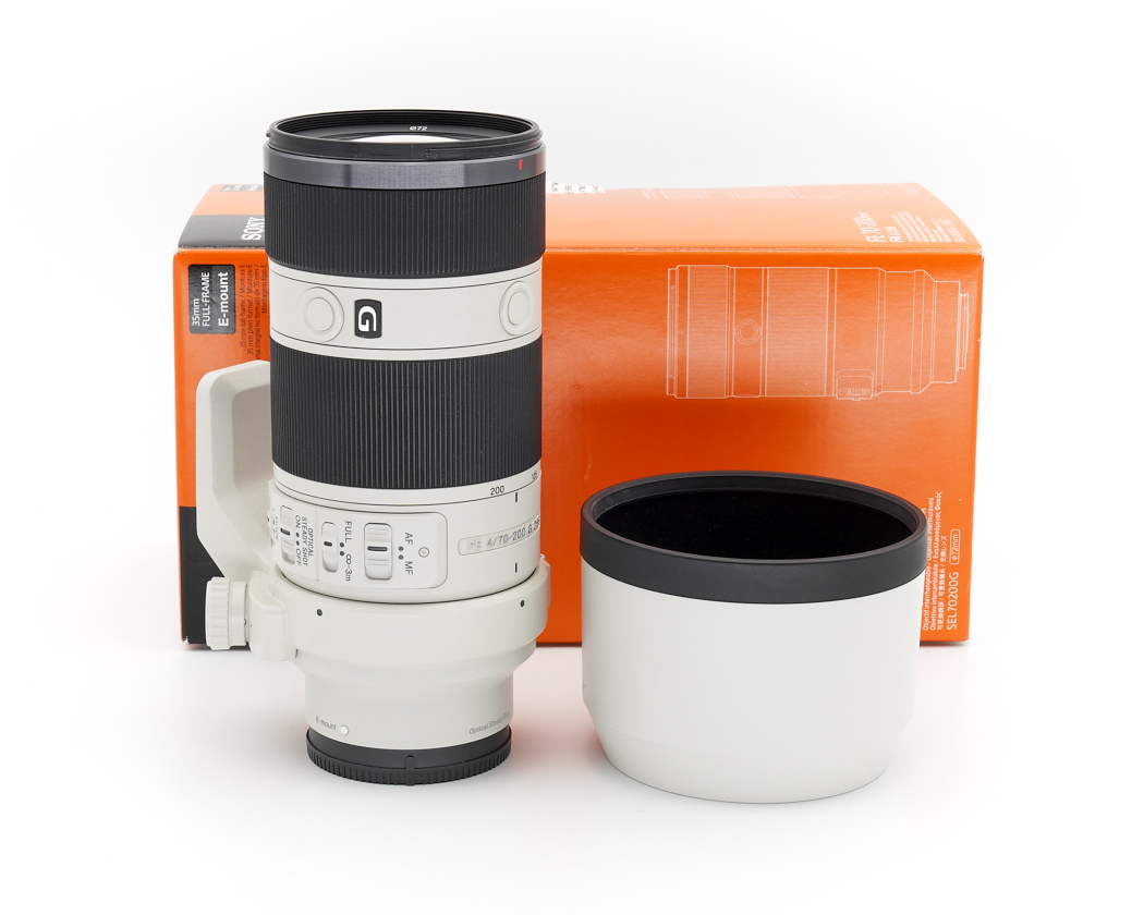 Teleobjektiv, Fotografielinse, Weißer Objektiv, Orangenverpackung, Kein Markenname sichtbar